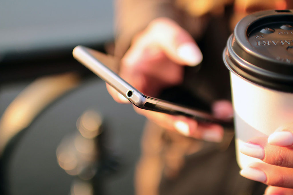 Person with coffee cup on the phone